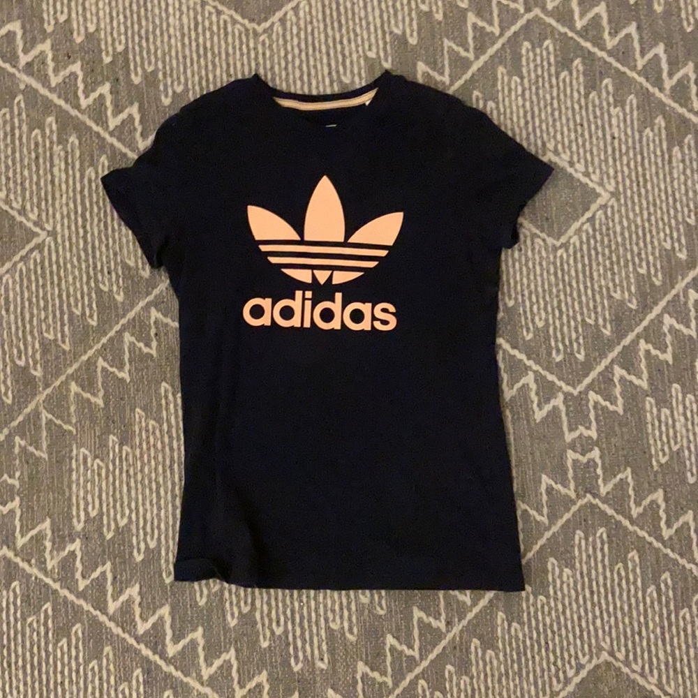 Adidas navy shirt with peach detailing.